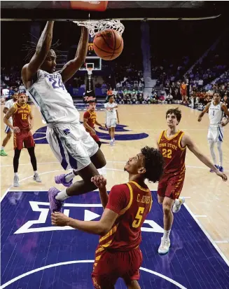  ?? Charlie Riedel/Associated Press ?? Kansas State’s Arthur Kaluma, left, scored 23 points as the Wildcats upset No. 6 Iowa State in the regular-season finale to provide a big boost to their NCAA Tournament hopes.