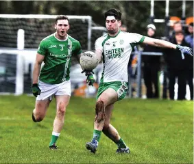  ??  ?? St. Molaise Gaels full back Liam Kennedy looks to intercept an Eastern Harps clearance. Photo: Tom Callanan.