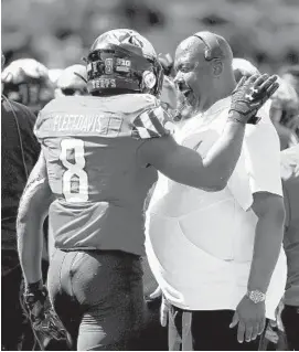  ?? WILL NEWTON/AP ?? Maryland running back Tayon Fleet-Davis celebrates with coach Michael Locksley after scoring a touchdown against Syracuse during the second half on Sept. 7.