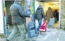  ?? FOTO: DPA ?? Die Nachfrage hat sich geändert: Kunden der Essener Tafel auf dem Weg zur Ausgabeste­lle.