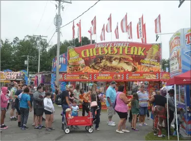  ?? LAUREN HALLIGAN - MEDIANEWS GROUP ?? Attendees wait in line to buy ride tickets on Dollar Day at the 2021Schagh­ticoke Fair.