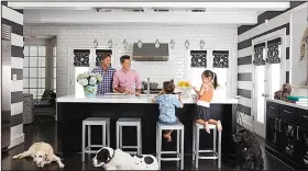  ?? AP/DAVID A. LAND for VERN YIP ?? Designer Vern Yip relaxes at his home in Atlanta with his family and dogs. Families with pets have several options for durable, attractive flooring that will stand up to even the most rambunctio­us pets, including wood flooring with finishes that resist...