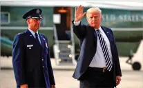  ?? PABLO MARTINEZ MONSIVAIS/ASSOCIATED PRESS ?? President Donald Trump waves Friday after arriving on Air Force One at Andrews Air Force Base. Watching is Air Force Col. Samuel Chesnut.