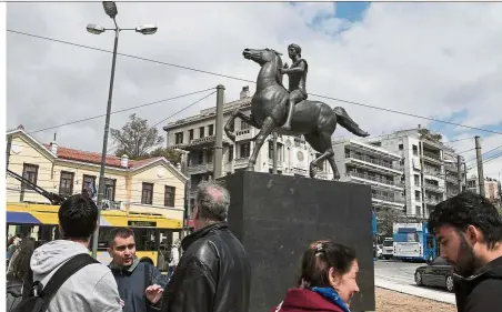  ??  ?? About time: People looking at the 3.5m statue of Alexander the Great, cast in bronze, after it was unveiled in central Athens.