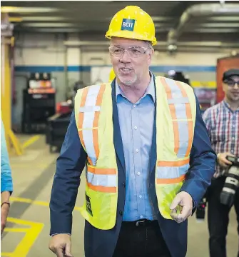  ??  ?? B.C. Premier John Horgan tours the Ironworker­s Training Facility at the B.C. Institute of Technology prior to announcing the new Crown corporatio­n overseeing hiring on provincial projects.