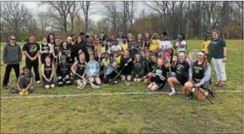  ?? SUBMITTED PHOTO ?? Interboro Middle School girls lacrosse coach Chris Goldberg, second from left, and Anderson Middle School (Philadelph­ia) coach Jody Mayer, right, got their teams together for a practice session and scrimmage at Manor Avenue Field in Essington last week.