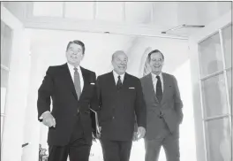  ?? BARRY THUMMA — THE ASSOCIATED PRESS FILE ?? Secretary of State George Shultz, center, walks with President Ronald Reagan and Vice President George Bush upon his arrival at the White House in Washington, after two days of arms talks with the Soviet Union in Geneva. Shultz, former President Reagan’s longtime secretary of state, who spent most of the 1980s trying to improve relations with the Soviet Union and forging a course for peace in the Middle East, died Saturday. He was 100.