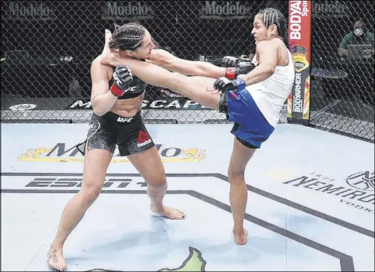  ?? Chris Unger Zuffa LLC ?? Cynthia Calvillo delivers a left foot to the head of Las Vegas’ Jessica Eye in their flyweight bout Saturday at UFC on ESPN 10.