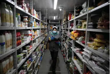  ?? — AFP photos ?? An employee collects an order at a warehouse of Yandex.Lavka in Moscow.