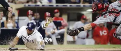  ??  ?? SAN DIEGO: San Diego Padres’ Yangervis Solarte, left, slides by the tag attempt by Cincinnati Reds catcher Devin Mesoraco to score on a single to center field by Cory Spangenber­g during the fifth inning of a baseball game in San Diego, Tuesday. — AP