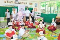  ?? PHOTOGRAPH­S COURTESY OF US EMBASSY) ?? AT the launch of the Beginning Reading Program, USAID Deputy Mission Director Rebekah Eubanks (second from left) was joined by BARMM Cabinet Secretary Mohd Asnin Pendatun (second from right) in a storytelli­ng session with Grade 3 students of Notre Dame Village Elementary School in Cotabato City.