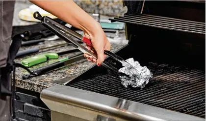  ?? TOM MCCORKLE FOR THE WASHINGTON POST ?? If you don’t want your fish to stick to the grill, make sure you clean the grates first. If you don’t have a grill brush, ball up aluminum foil and use it on heated grates to scrape away cooked-on food before putting your fish on to cook.