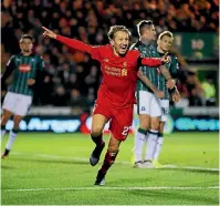  ??  ?? Lucas Leiva celebrates scoring for Liverpool against Plymouth.