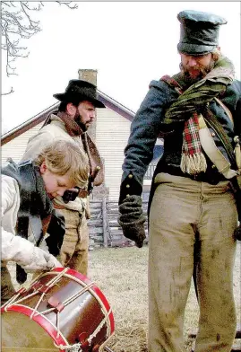  ?? FILE PHOTO ?? Re-enactors camp and work together as families and look forward to the camp as a time to catch up with friends seen only during re-enactment gatherings, says Steve Bailey, the organizer of the re-enactment of the 1862 Battle of Pea Ridge. These men...