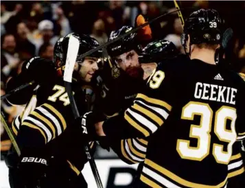  ?? DANIELLE PARHIZKARA­N/GLOBE STAFF ?? Justin Brazeau (center) provided a needed net-front presence for the Bruins’ second power-play unit and produced a pair of goals against the Senators.