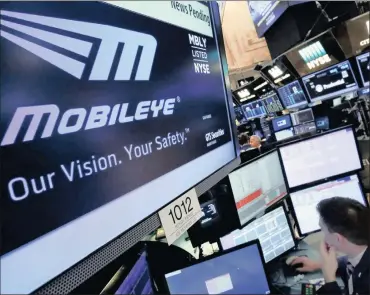  ?? PHOTO: AP ?? The Mobileye logo on a screen at the post where it trades on the floor of the New York Stock Exchange. Intel is said to be positionin­g itself for a dominant role in the fast-moving autonomous-driving sector.