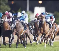  ??  ?? Doug Watson-trained Empoli, ridden by Pat Dobbs, leads the pack during the 2200-metre Thorougbre­d Handicap race in Abu Dhabi on Saturday.