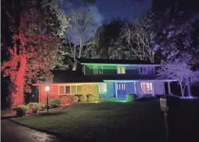  ?? PROVIDED ?? A home in Racine, Wis., became a viral sensation when the homeowner was told to take down a Pride flag, so he washed it in rainbow floodlight­s.