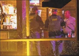  ?? Patrick T. Fallon For The Times ?? AUTHORITIE­S search Borderline Bar and Grill after a gunman opened fire the night of Nov. 7. The gunman killed himself after a chaotic firefight with police.