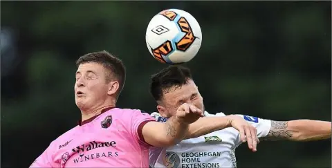  ??  ?? Ryan Nolan of Wexford F.C. battles it out in the air with Cabinteely’s Jack Watson.