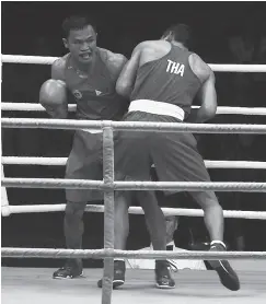  ?? (Photo by Christian Maningo) ?? CHARLEY Suarez in action next to Thailand’s Khunatip Pidnuch in the men’s lightweigh­t (60kg) division finals. Suarez won via unanimous decision for this fourth SEAG gold medal.