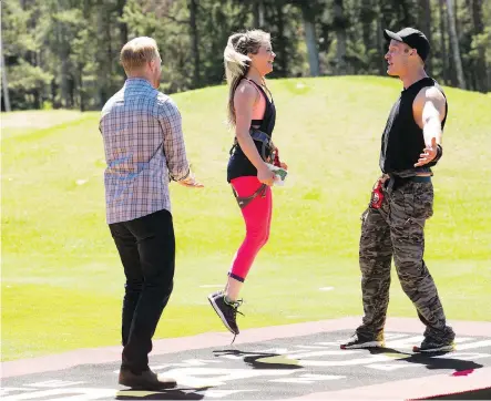  ??  ?? Calgary first responders Courtney Berglind and Adam Kovacs celebrate reaching the mat first on Amazing Race Canada: Heroes Edition.