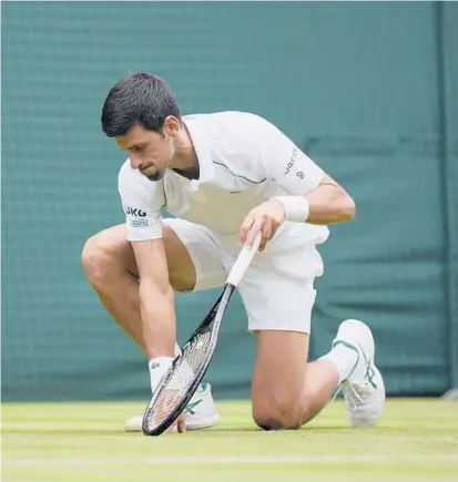  ?? ALASTAIR GRANT/AP ?? Novak Djokovic gets up after slipping on the grass during his second-round victory over Kevin Anderson on Wednesday.