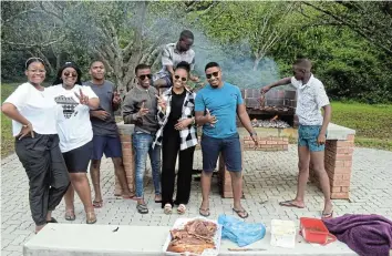  ?? Picture: TK MTIKI ?? CHISA NYAMA: Gqeberha (Port Elizabeth) residents picnicking and enjoying a braai at the newly-renovated Krantz on Tuesday. The group said they were here to explore and enjoy the beauty of Port Alfred. From left, are Ngade Philisiwe, Nxayi Kulungile, Lonwabo Ndoko, Tyongwana Phaphama, Sandiso Buzani, Asanda Paraffin, Yonga Mxathule and Landise Madywabe