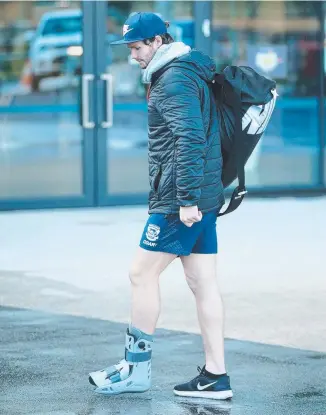 ?? Picture: ALISON WYND ?? Patrick Dangerfiel­d wears a moon boot on his injured foot yesterday.