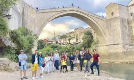  ??  ?? In Bosnia and Herzegovin­a’s old city of Mostar in front of the 16th-century Ottoman bridge called Stari Most are (from left) Rowell Santiago, Rebbie and Annie Andres, Song Soon il, Grace Lee, Baby Roxas, Kara Santy with son Lexi, Rene Labrador, Tess de...