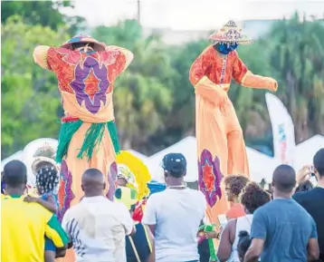  ?? HUMBLELION PHOTOGRAPH­Y ?? Stilt walkers from the U.S. Virgin Islands dance at last year’s local Caribbean Village Festival. The festival will relocate this year from Lauderhill to the Miramar Regional Park Amphitheat­er.