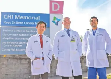  ?? STAFF PHOTO BY OLIVIA ROSS ?? Doctors Tru-Khang Dinh, Justin Wilkes and Rishabh Shah stand in front of CHI Memorial's Rees Skillern Cancer Institute on Friday.