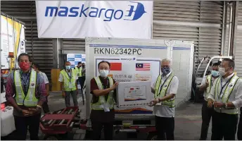  ?? — Bernama photo ?? Senior minister (Security Cluster) datuk Seri ismail Sabri Yaakob (front, second right) receives a package containing Sinovic vaccines from China’s ambassador to malaysia, ouyang Yujing, at the klia. also present are khairy (front, left) and Foreign minister datuk Seri hishamuddi­n Tun hussein (front, right).