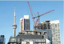  ?? THE CANADIAN PRESS FILES ?? Above: Constructi­on cranes are seen over Toronto in July. The huge bureaucrac­ies set up to assess the values of properties impose large costs on taxpayers, and the debate over whether the process is fair is far from settled.