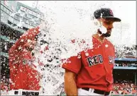  ?? Winslow Townson / Getty Images ?? Red Sox starting pitcher Nathan Eovaldi gets water dumped on him after pitching a complete game in their 5-3 win over the Baltimore Orioles in Game One of a doublehead­er at Fenway Park on Saturday.