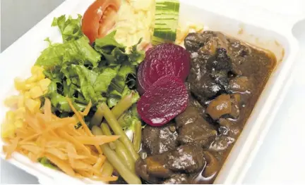  ??  ?? Stew pork with a salad substitute­d for rice and peas