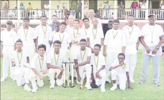  ??  ?? Under - 15 champs pose for a photo along with Coach Gavin Nedd, President of the GCA, Roger Harper and CEO of Toucan distributo­rs Andrew King (Orlando Charles photo)