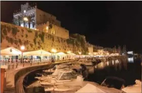  ??  ?? People dining on the coast of Ciutadella on the island of Menorca, Spain. The city was the island’s fortified capital until Turks sacked it and the British moved the capital across the island to Mahon.