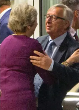  ??  ?? Kiss of the Eurocrat: The European Commission president Jean-Claude Juncker embraces Theresa May and David Davis after last night’s meeting in Brussels