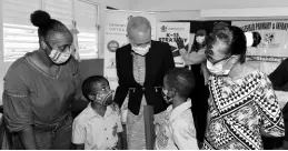  ?? CONTRIBUTE­D ?? Minister of Education, Youth and Informatio­n Fayval Williams (centre) converses with students of Bellefield Primary and Infant School in Manchester, six-year-old Jayden Perron (second left), and 10-year-old Terone Thompson, following a ceremony at the institutio­n on Friday for the presentati­on of tablet computers. Looking on are the youngsters’ mother, Nickole King (left), and the school’s principal, Brenda Ayles-Anderson.