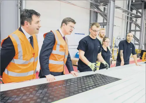  ??  ?? UNLOCKING POTENTIAL: Business Secretary Greg Clark and Siemens UK CEO Professor Juergen Maier talk to manufactur­ing workers in Hull.