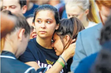  ?? AP PHOTO/GERALD HERBERT ?? Julia Salomone, 18, left, and her sister Lindsey Salomone, 15, student survivors from Marjory Stoneman Douglas High School ,hug as they march to the state capitol in Tallahasse­e, Fla. to challenge lawmakers on gun control reform.