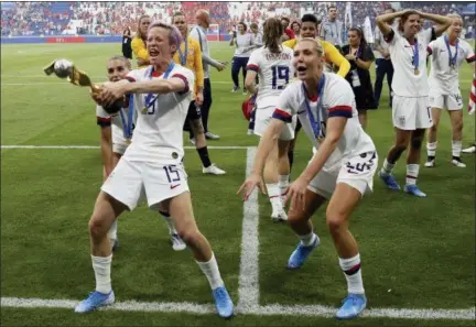  ?? DAVID VINCENT - THE ASSOCIATED PRESS ?? United States’ Megan Rapinoe , left, celebrates with teammates their victory in the Women’s World Cup final soccer match between US and The Netherland­s at the Stade de Lyon in Decines, outside Lyon, France, Sunday, July 7, 2019. US won 2:0.