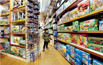  ?? AP Photo/Richard Drew ?? ■ A young customer checks out the merchandis­e Monday at Mary Arnold Toys on Manhattan’s Upper East Side. Mary Arnold, a nearly 90-year-old store, is thriving along with many other small and independen­t toy stores, even as Toys R Us is going out of...