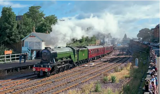  ?? Andy Mason ?? BELOW: 60103 Flying Scotsman
departs Scarboroug­h with a charter to London on June 24, 2017, with 47760 on the rear – this is the train where Pip Dunn observed numerous trespass incidents when he went out to watch it come through his local area. The lure of Flying Scotsman
brings out many onlookers, as can be seen along Scarboroug­h’s Westwood Wall on the right.