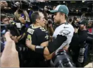  ?? BILL FEIG — THE ASSOCIATED PRESS ?? New Orleans Saints quarterbac­k Drew Brees (9) speaks with Philadelph­ia Eagles quarterbac­k Nick Foles after Sunday’s NFL divisional playoff football game in New Orleans.