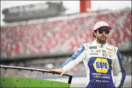  ?? Chris Graythen / Getty Images ?? Chase Elliott stands on the grid during qualifying at Talladega Superspeed­way on Saturday.