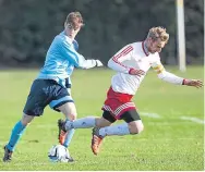  ??  ?? The tackles were flying in this FC Polonia (white) v Dundee Social contest.