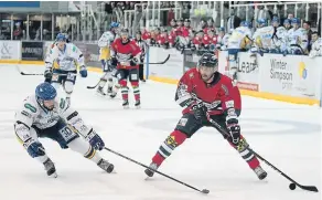  ??  ?? Stars’ Jimmy Jensen comes under pressure from Flyers’ Chris Wands when the teams met at DIA at the weekend. Stars won 7-5.