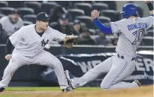  ?? FRANk FRANkLIN II/ THE ASSOCIATED PRESS ?? Jays' Josh Donaldson slides to third as Yankees third baseman Chase Headley waits for the ball.